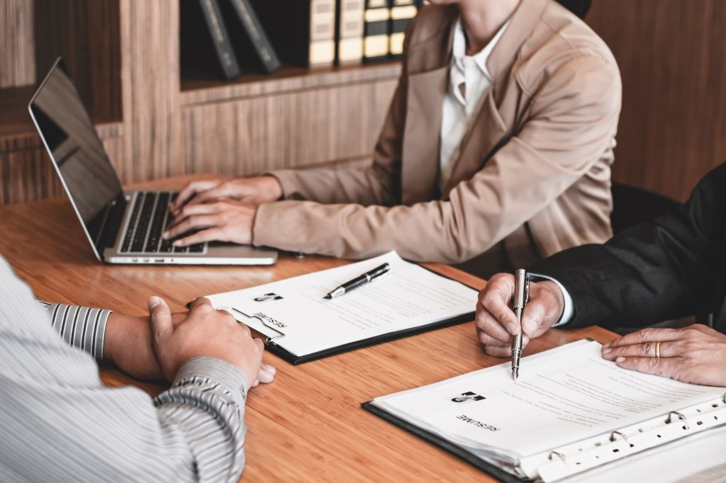 Examiner reading a resume during job interview at office Business and human resources concept.