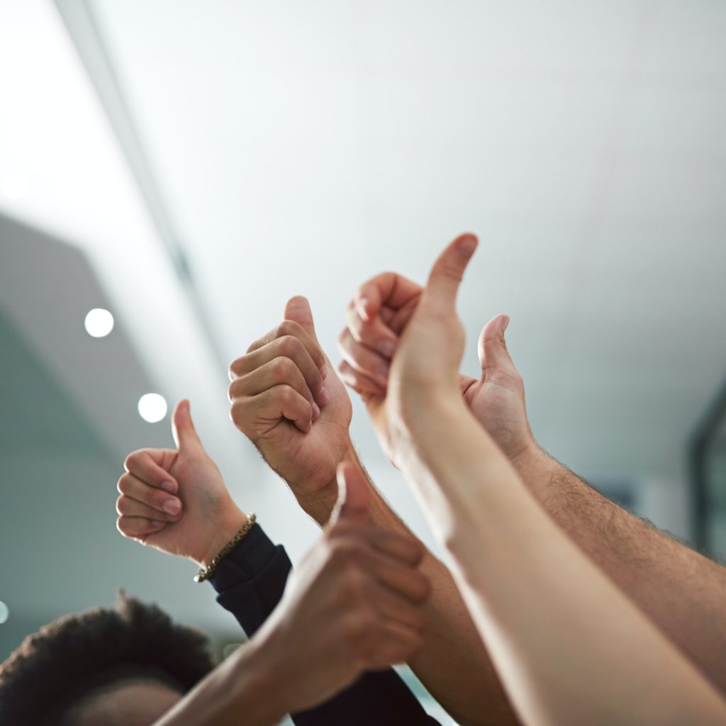 We say yes to success. Cropped shot of various peoples hands showing thumbs up.